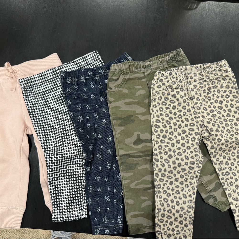 Bundle of pants & white onesies.
